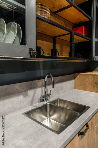 Interior of modern kitchen with metal sink