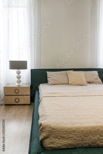 Light bedclothes on bed in cozy bedroom