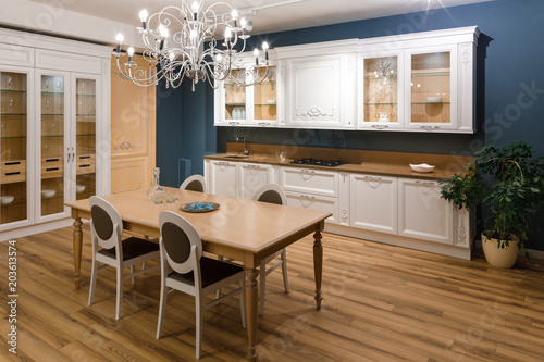 Принти на полотні Table with chairs in stylish kitchen with chandelier