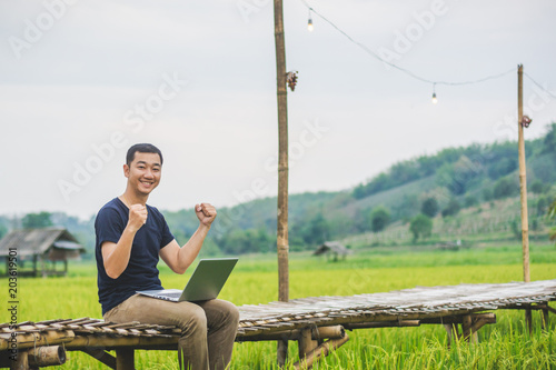 Asian young businessman working on his laptop. Digital Economy.
