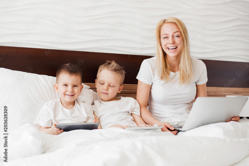  Family with gadgets in bed