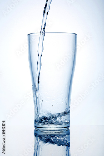 Glass cup with water on a white background.