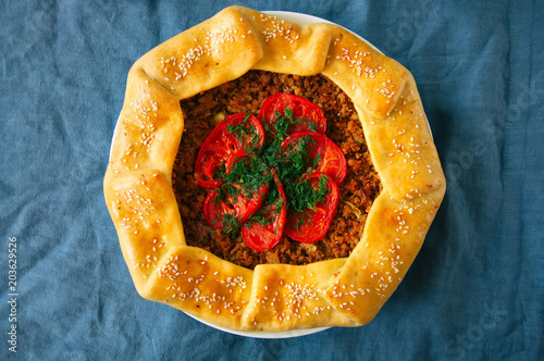 Saudi aysh abu laham or Saudi pizza or meat galette, traditional arabic and middle eastern food concept. photo