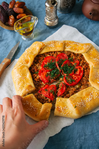 Saudi aysh abu laham or Saudi pizza or meat galette, traditional arabic and middle eastern food concept. photo