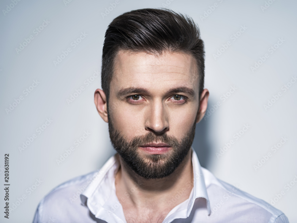 Obraz premium Handsome man in white shirt. Closeup portrait.