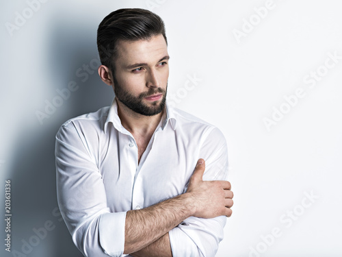 Handsome man in white shirt. Closeup portrait.