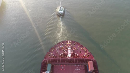 From above: Tugboat engaged  in bow-to-bow operation with a freighter