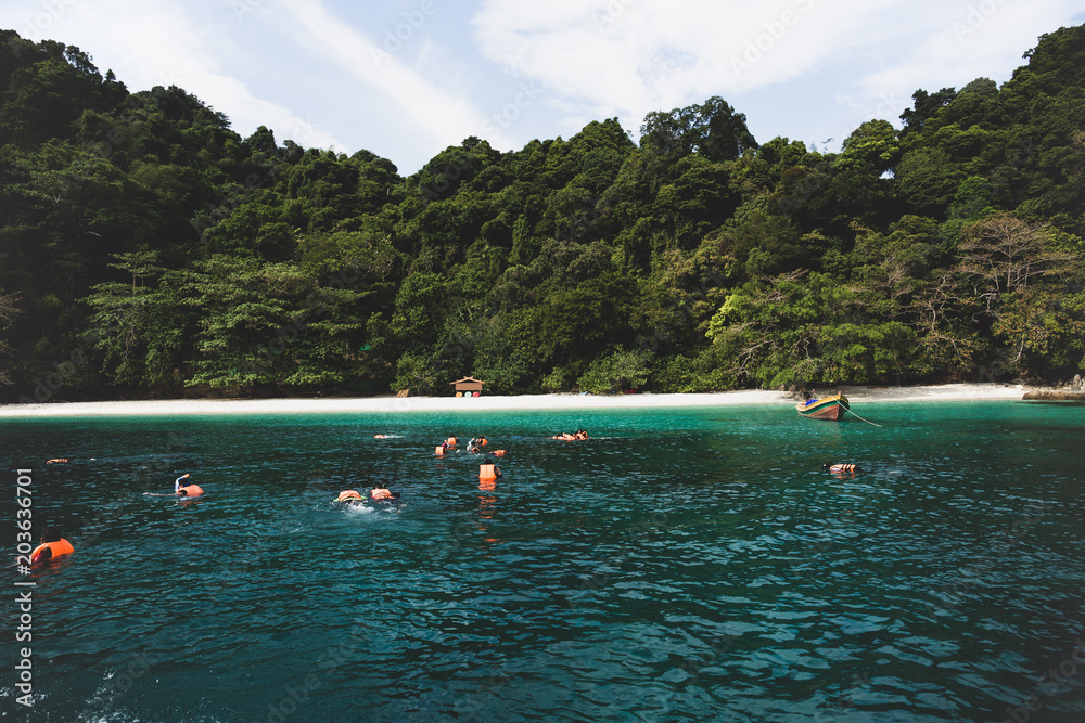Obraz premium Cinematic color group of tourist doing snorkeling at Flower Island
