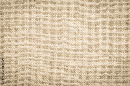 Hessian sackcloth woven fabric texture background in beige cream brown color