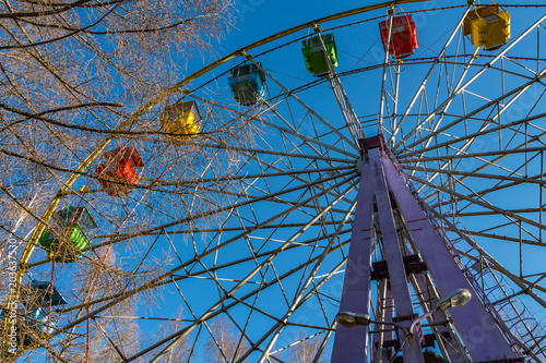 Yekaterinburg, Russia - 05 02 2018: A group of colorful blue, green, red, yellow cabs of ferris wheel in the park in spring