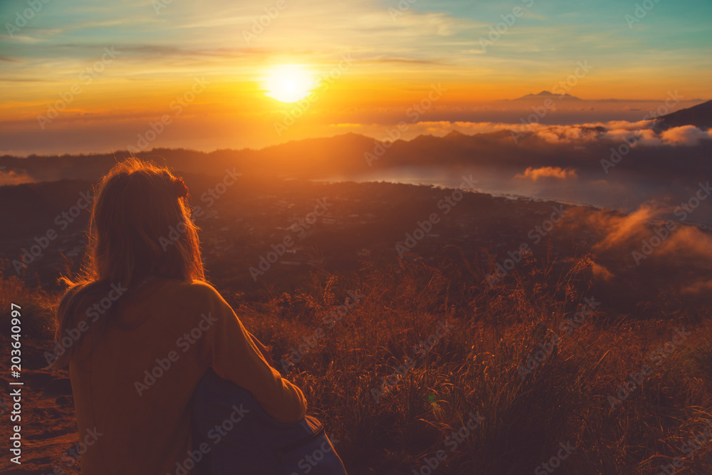 Girl enjoying the view from Mountain Batur volcano, Bali, Indonesia.