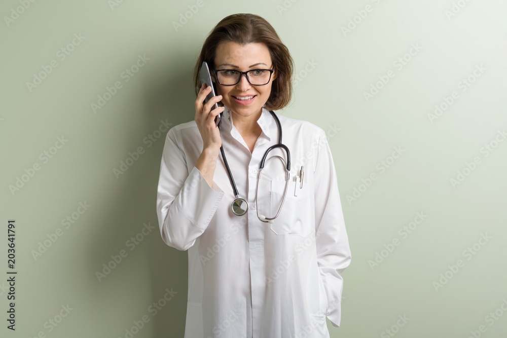 Positive doctor woman talking mobile phone