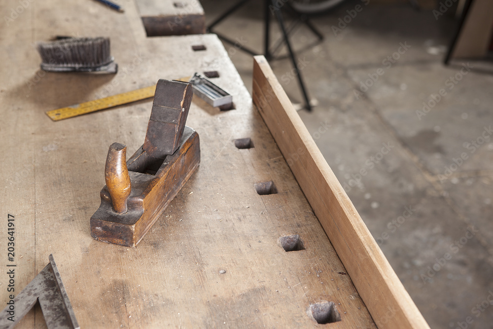 carpenter hand plane on wooden background.copy space