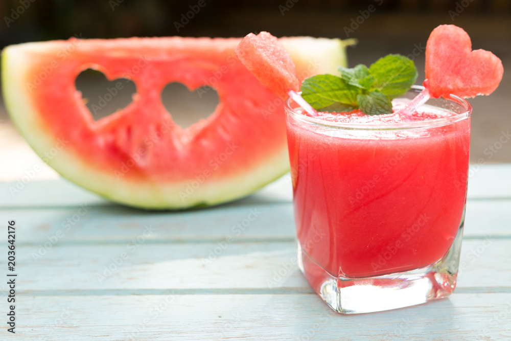 Watermelon juice and slice of delicious ripe watermelon with heart shape Watermelon juice and slice of delicious ripe watermelon with heart shape