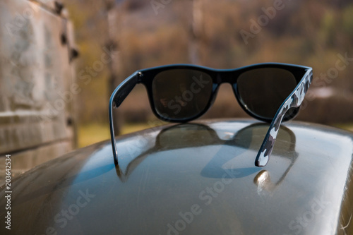 Sunglasses in an old military car, spring day