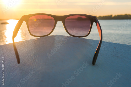 Sunglasses on the beach, bright summer day