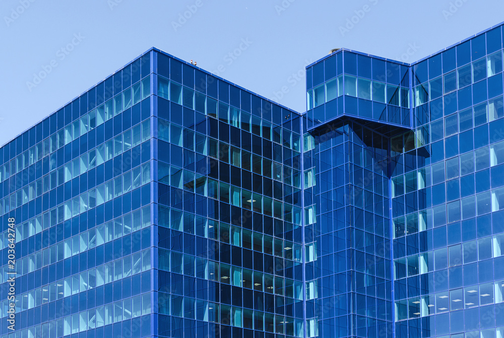 Modern office building made of blue glass. Modern office building made of blue glass.