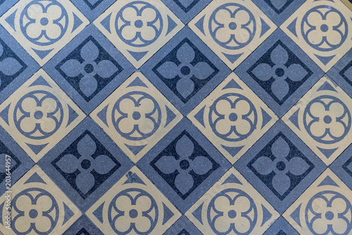 Old blue and beige floor tiles with geometric pattern 
