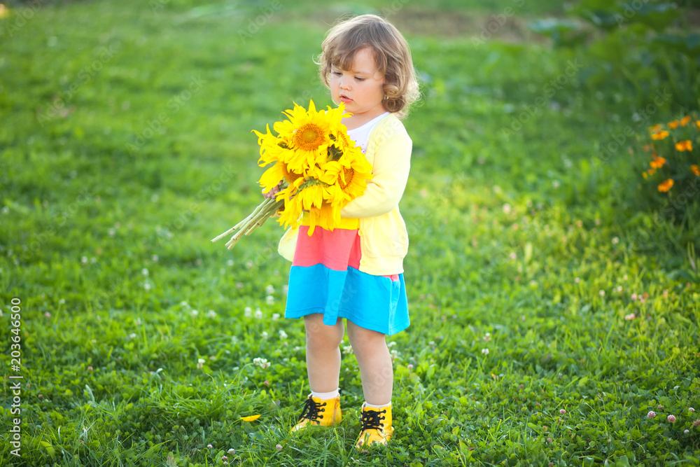 Happy child with bouquet of beautiful sunflowers Happy child with bouquet of beautiful sunflowers