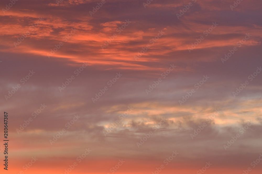 Nature background of vibrant colorful sunset clouds