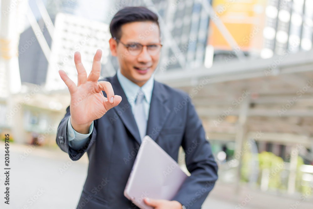 Happy young businessman make okay gesture. okay symbol. Happy young businessman make okay gesture. okay symbol.