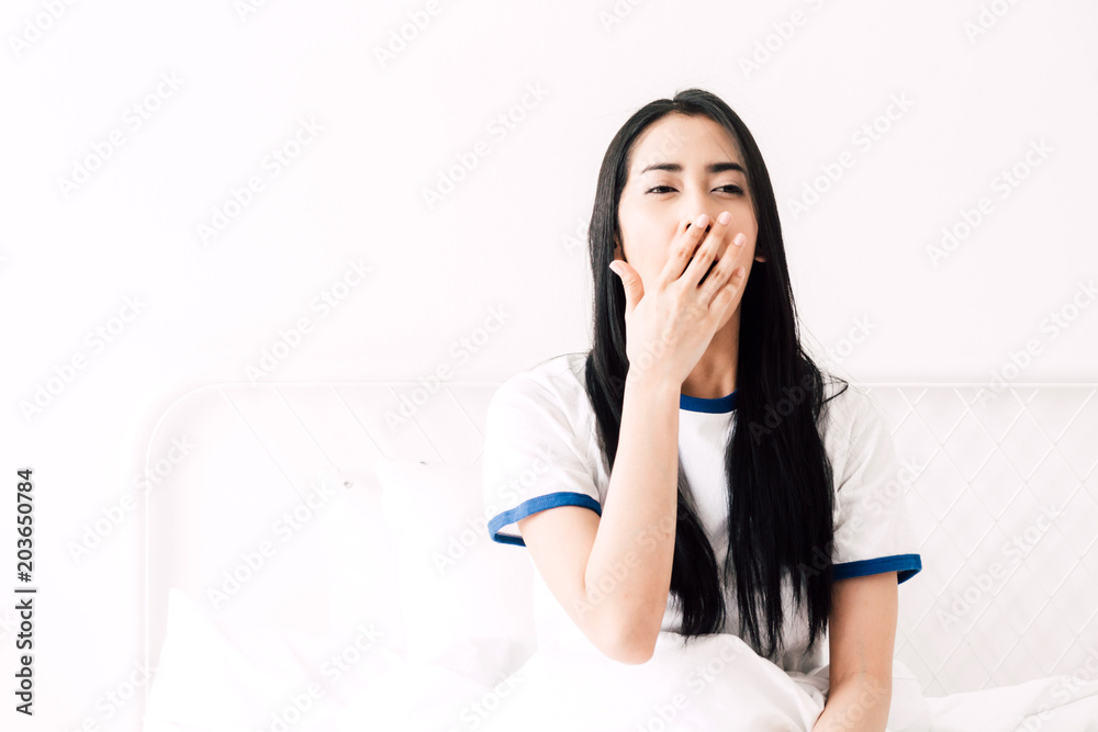 Woman stretching happy and relaxed after wake up in the morning at home Woman stretching happy and relaxed after wake up in the morning at home