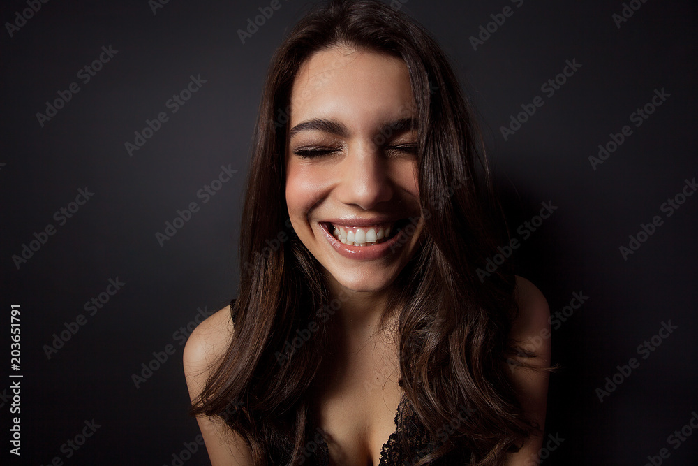 Beautiful woman portrait laughing with closed eyes