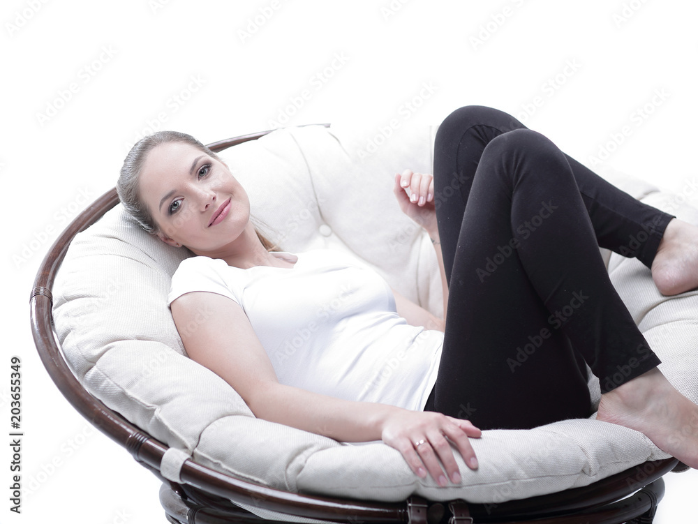 tired woman resting in an easy chair made of rattan tired woman resting in an easy chair made of rattan