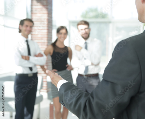 background image of businessman holding out hand for a handshake. © ASDF