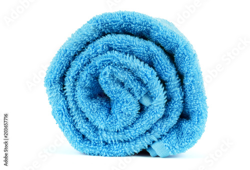Rolled up blue towel isolated on white photo