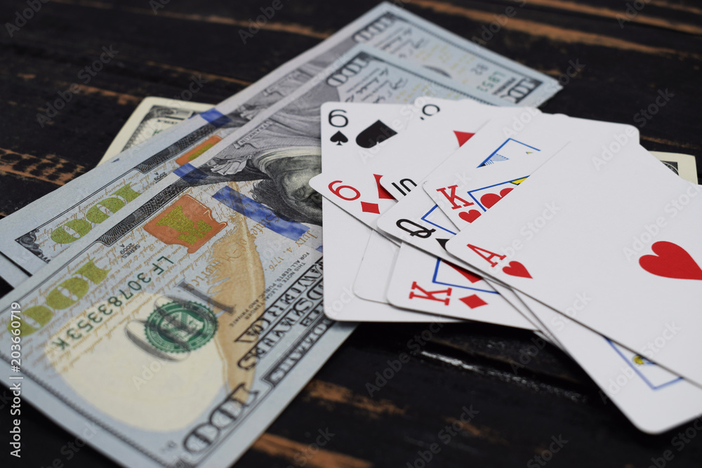 gambling, playing cards for money, on the table dollars and playing cards