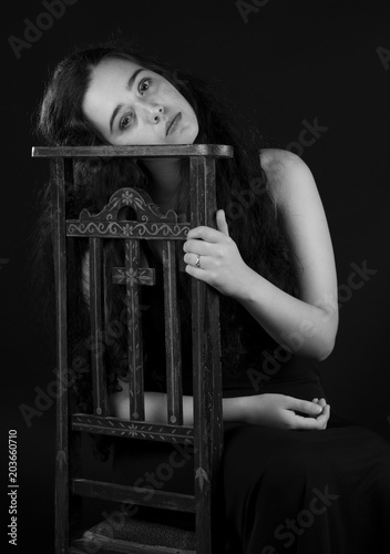 Young woman sitting on an old chair photo