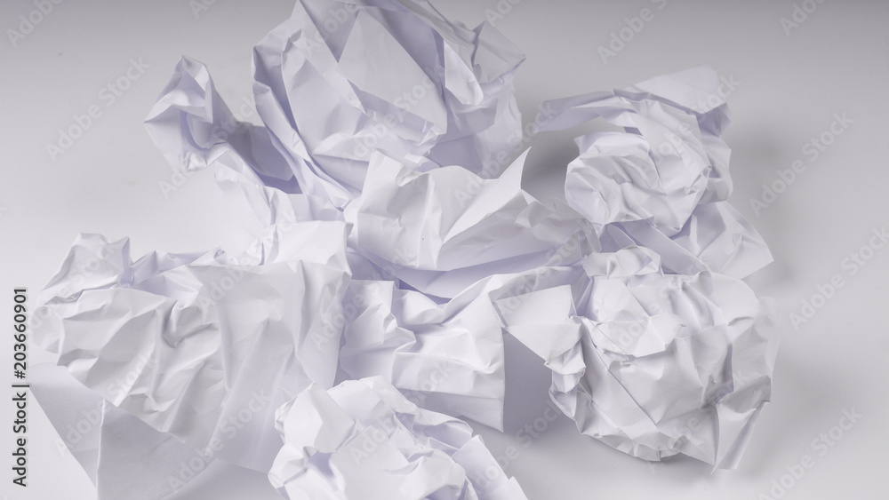 crumpled paper on white table crumpled paper on white table