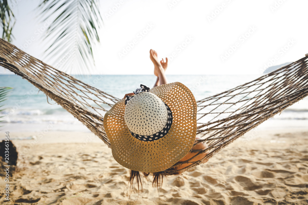 © Peera - Happy woman relaxing in hammock
