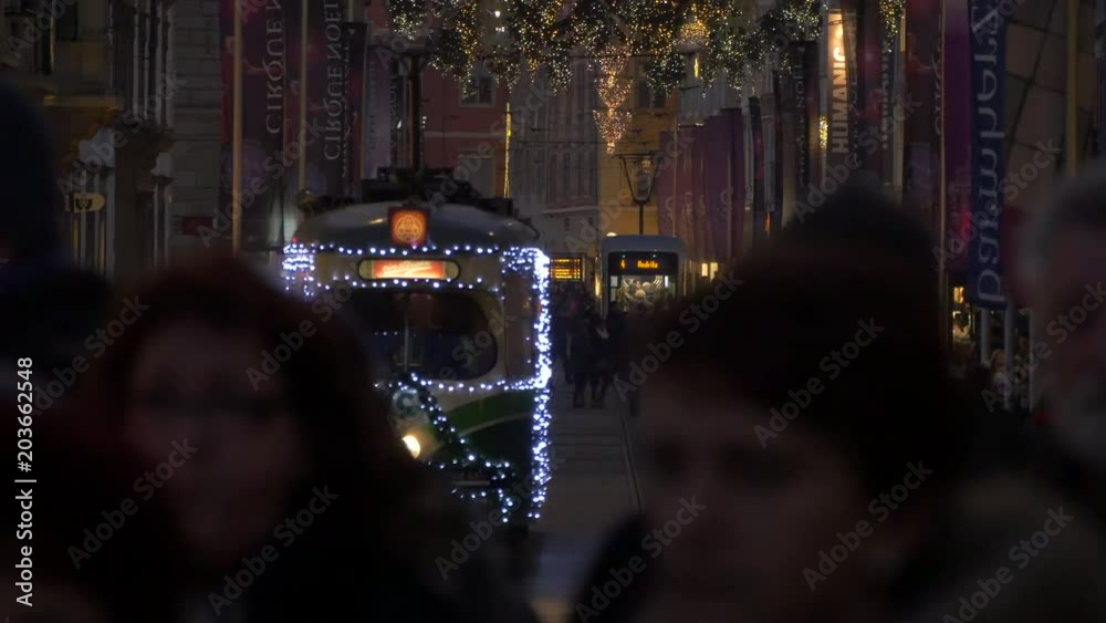Illuminated tram passing on the street Illuminated tram passing on the street