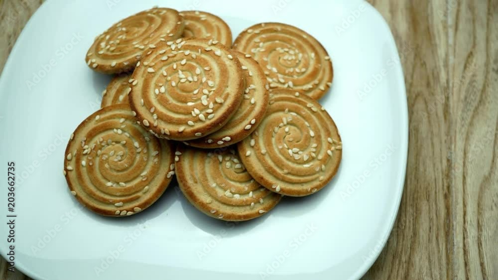 Fresh biscuits on the plate. On a rotating white background. Wooden table. 4K Fresh biscuits on the plate. On a rotating white background. Wooden table. 4K
