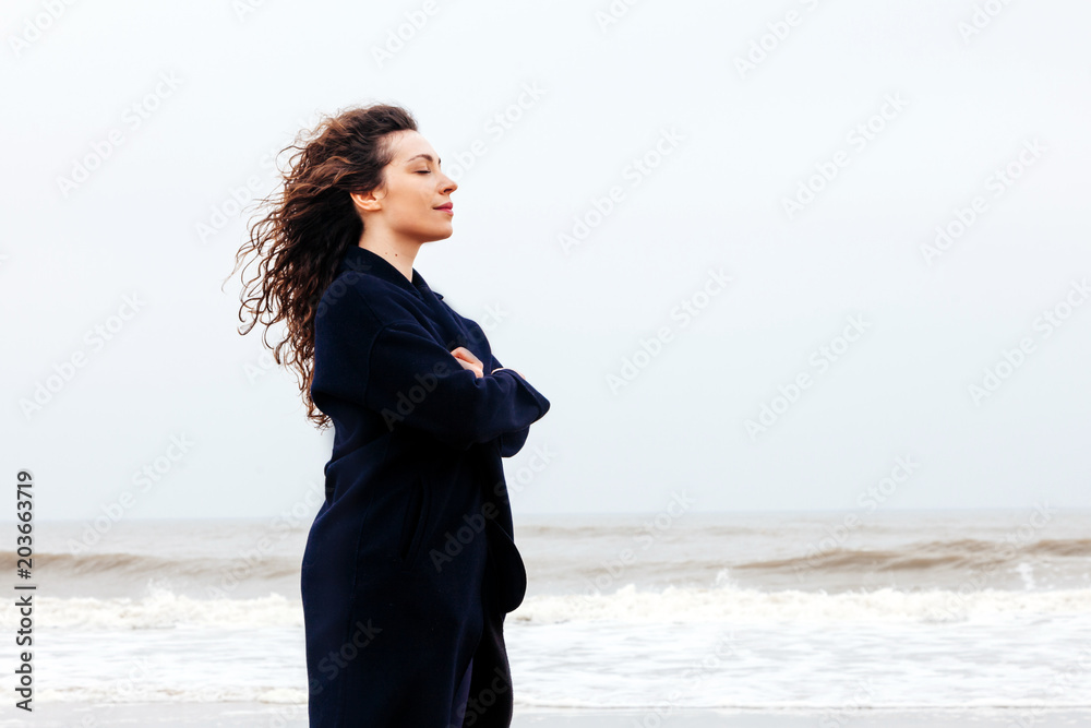 Girl rain sea wind winter portrait woman smile spring coat long hair curly mood shore snow beach Girl rain sea wind winter portrait woman smile spring coat long hair curly mood shore snow beach