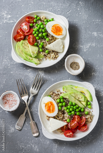 Savory breakfast grain bowl. Balanced buddha bowl with quinoa, egg, avocado, tomato, green pea. Healthy diet food concept. Top view, flat lay
