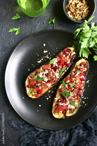 Grilled eggplant stuffed with tomatoes, nuts, pomegranate and yogurt dressing.Top view.