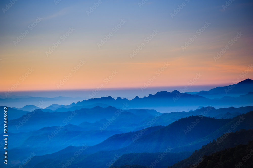 Night sky before sunrise in top of view of beauty blue shade mountain range  in the early morning dawn.