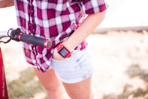 BUCHAREST, ROMANIA, - October 26, 2017: Person using smart watch and a smartphone walking on the park in a sunday. Woman making gestures on a wearable smart watch. Illustrative editorial content.