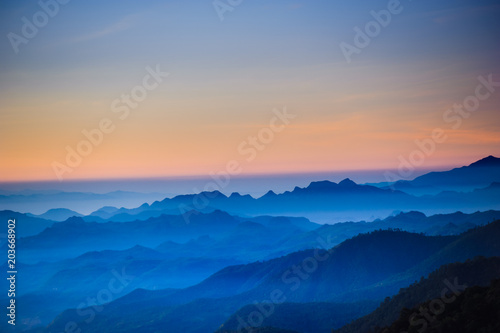 Night sky before sunrise in top of view of beauty blue shade mountain range in the early morning dawn.
