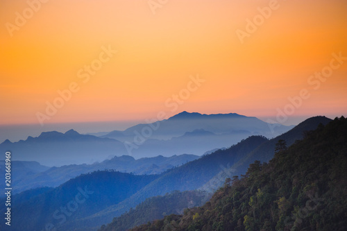 Beautiful mountains with shades of orange scenery in the early morning dawn. © OHishi_Foto