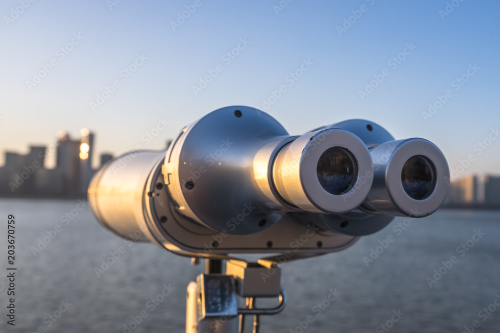 telescope with cityskyline