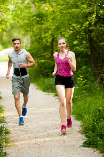 Active young couple running in the park