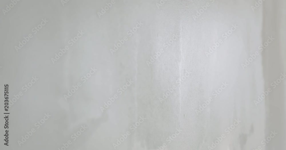 Slow motion handheld shot of worker applying putty on the wall Slow motion handheld shot of worker applying putty on the wall