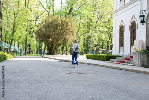 Wallpaper Mural Woman using electric scooter in the park on a sunny day Torontodigital.ca