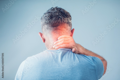 Young man suffering from neck pain. Headache pain.
