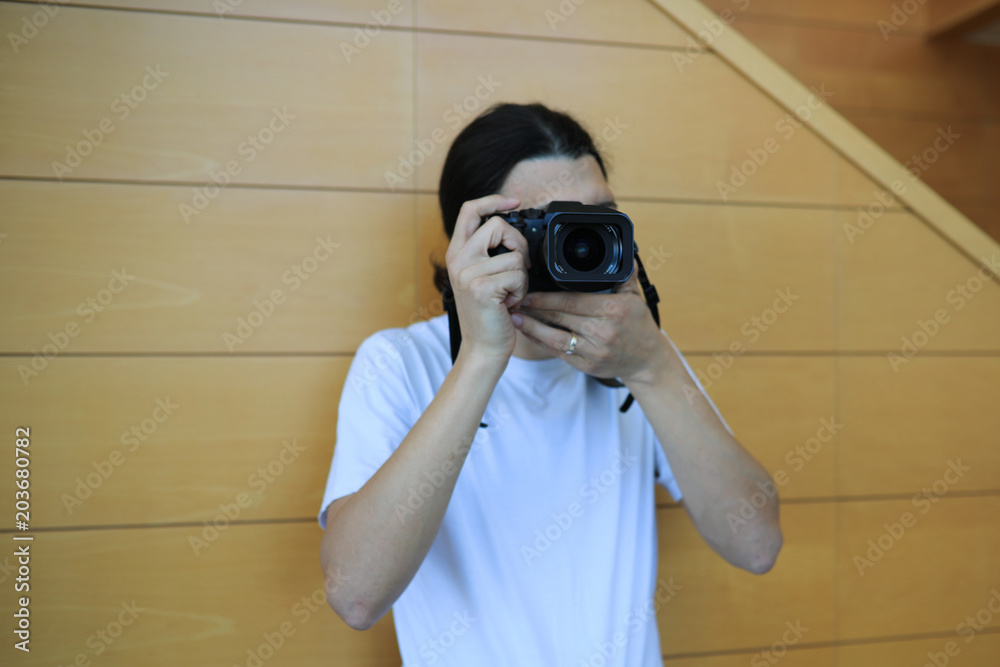 Hipster taking a picture with a photo camera view from the side Hipster taking a picture with a photo camera view from the side