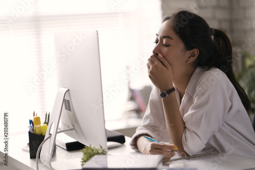 Businesswoman, yawned she was tired of working in an office. photo